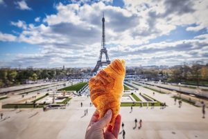 Afrench Croissant in front of the Eiffel Tower in Paris
